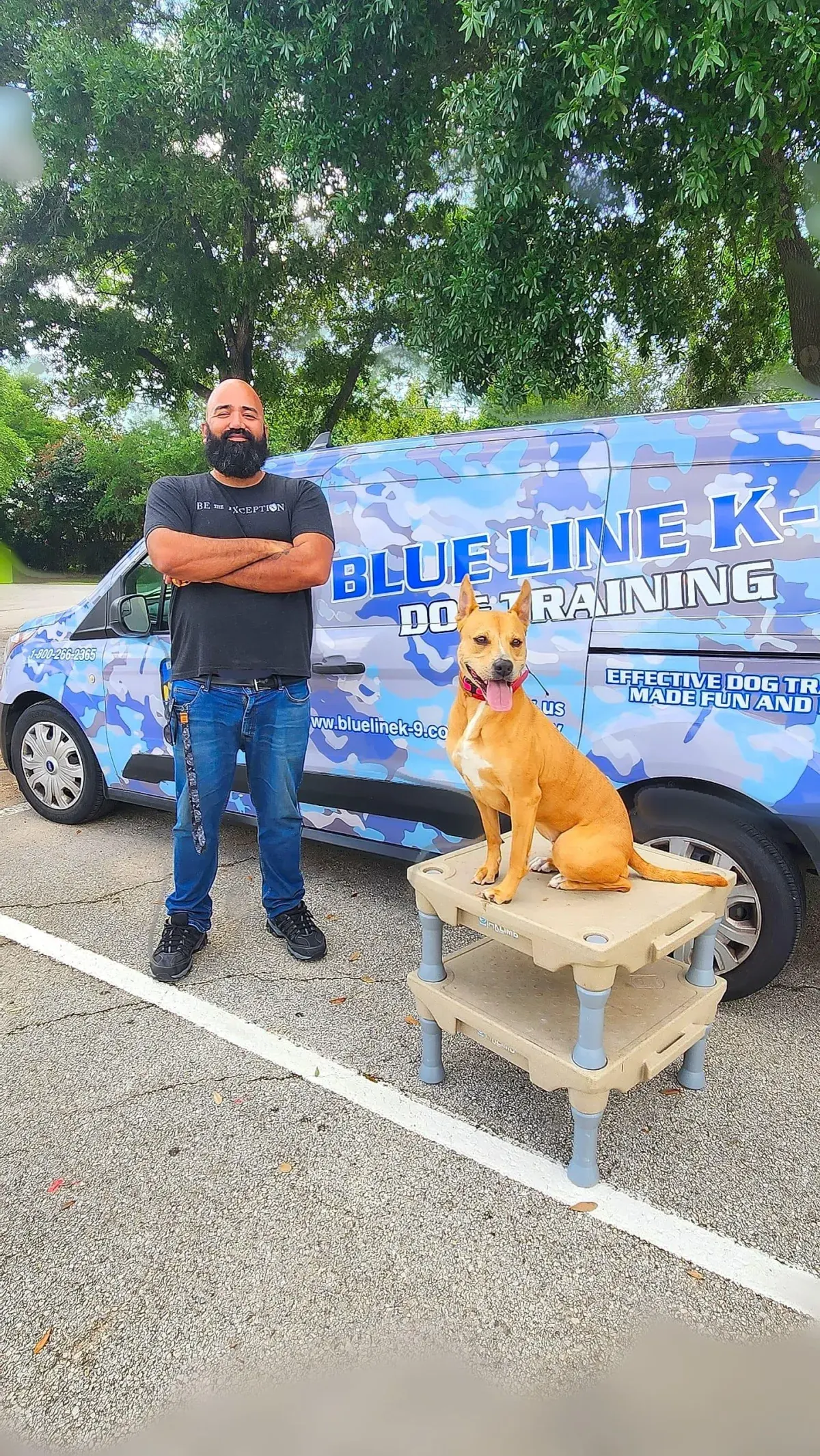 Blue Line K-9 trainer in Katy, TX with a trained dog beside the branded van